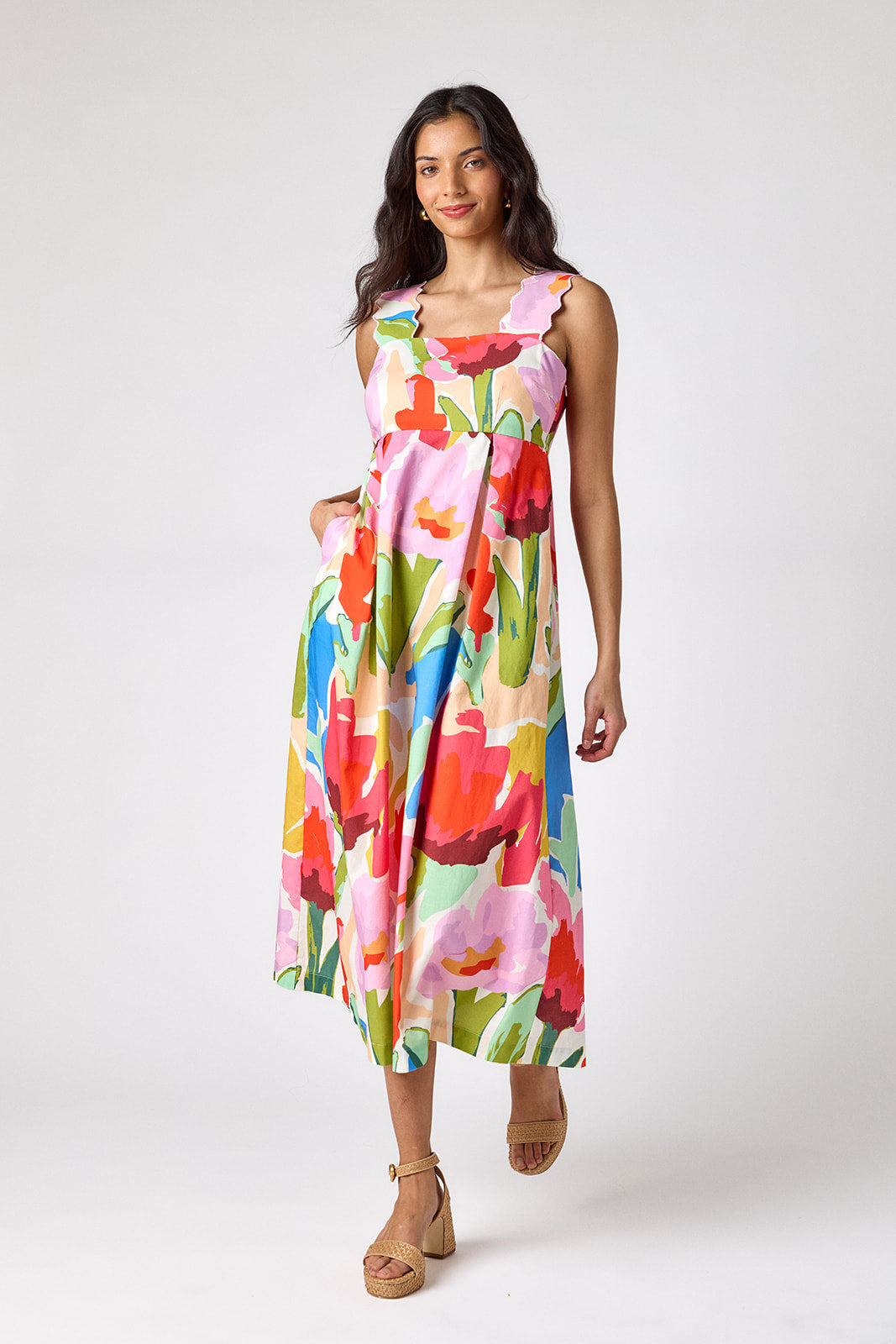 Painted Petals midi dress with fitted bodice and wavy straps on model — CROSBY by Mollie Burch