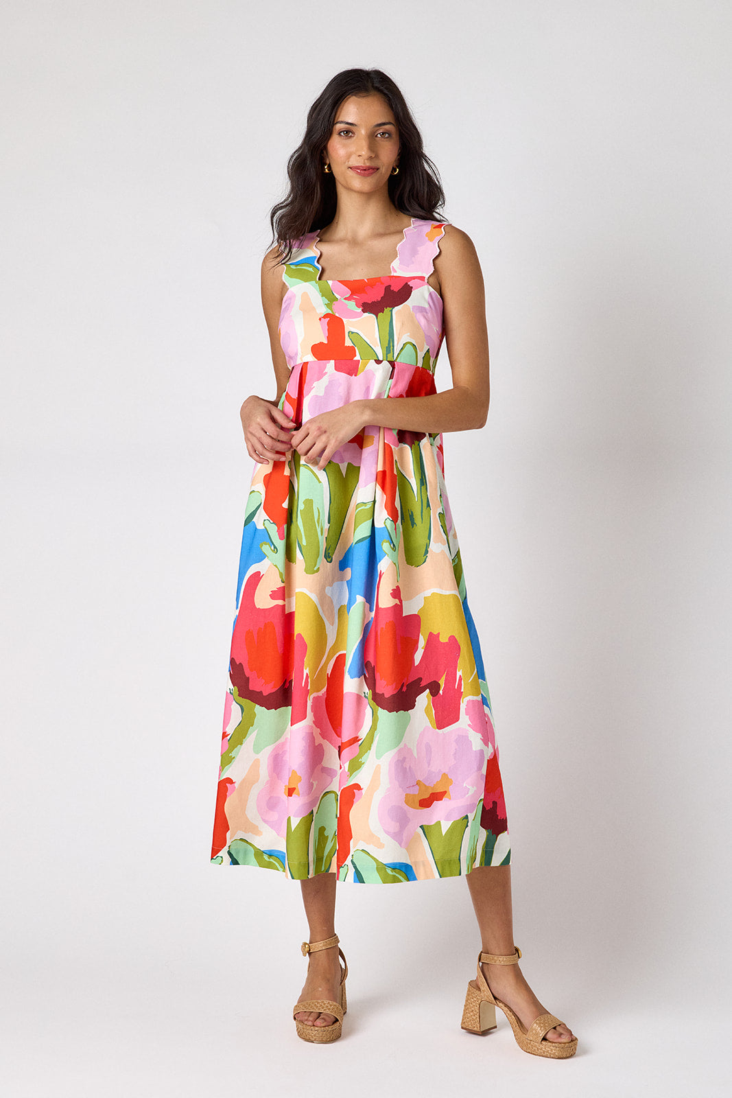 Painted Petals midi dress with fitted bodice and wavy straps on model — CROSBY by Mollie Burch