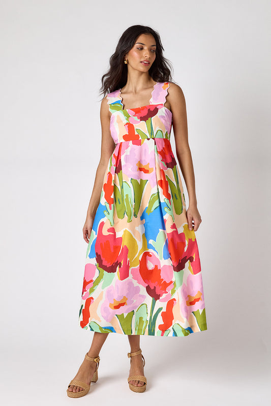 Painted Petals midi dress with fitted bodice and wavy straps on model — CROSBY by Mollie Burch