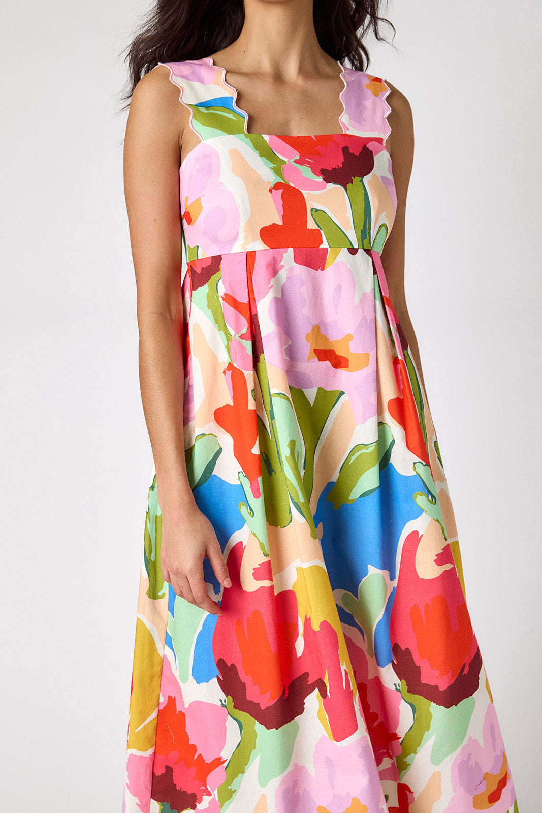 Painted Petals midi dress with fitted bodice and wavy straps on model — CROSBY by Mollie Burch