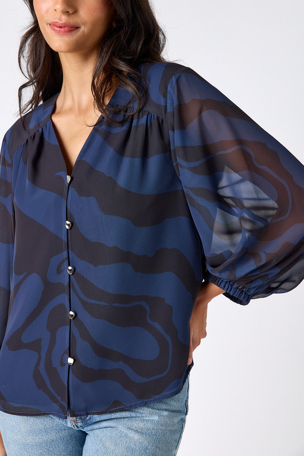 Ink Wave button-front v-neck blouse with voluminous sleeve on model – CROSBY by Mollie Burch