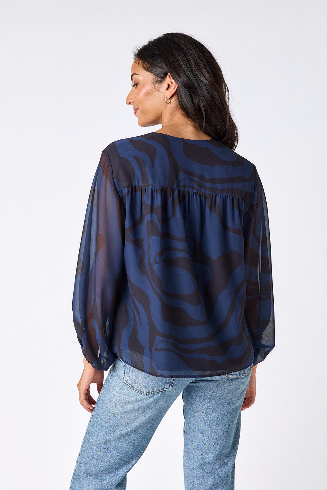 Ink Wave button-front v-neck blouse with voluminous sleeve on model – CROSBY by Mollie Burch