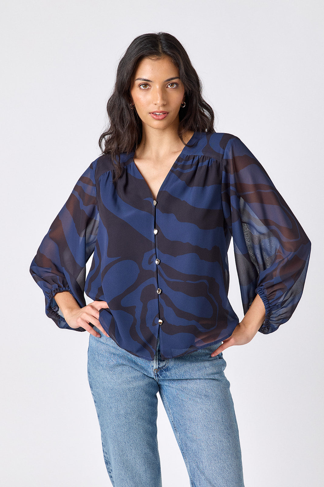 Ink Wave button-front v-neck blouse with voluminous sleeve on model – CROSBY by Mollie Burch