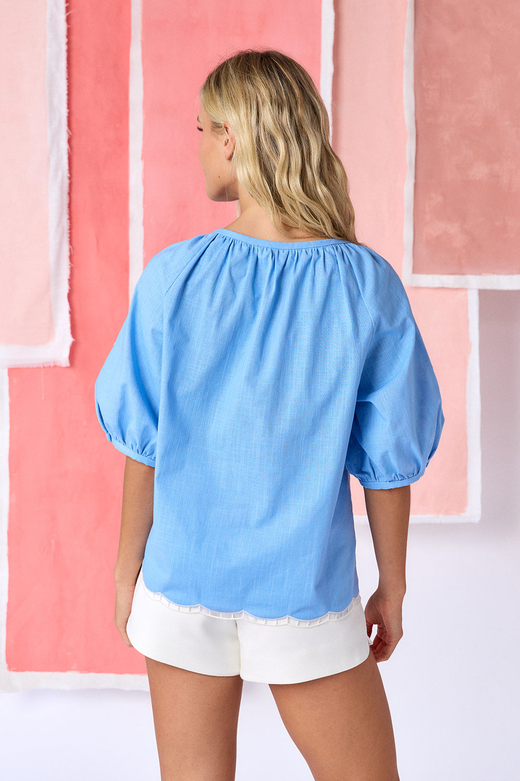 Model wearing tailored shorts in ivory, featuring a flat front, elasticized back waistband, and a slightly spacious leg opening — CROSBY by Mollie Burch