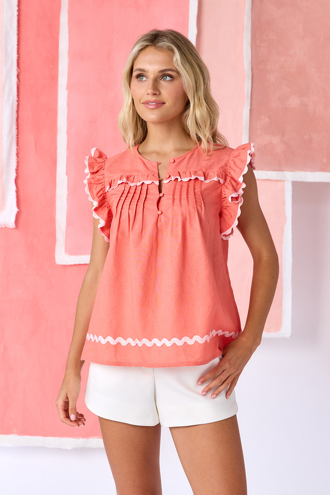 Model wearing tailored shorts in ivory, featuring a flat front, elasticized back waistband, and a slightly spacious leg opening — CROSBY by Mollie Burch