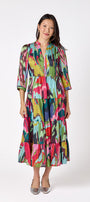 Macrostie Dress in Life of the Party featuring a tiered midi skirt and gold-accented buttons on model – CROSBY by Mollie Burch