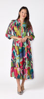 Macrostie Dress in Life of the Party featuring a tiered midi skirt and gold-accented buttons on model – CROSBY by Mollie Burch