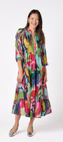 Macrostie Dress in Life of the Party featuring a tiered midi skirt and gold-accented buttons on model – CROSBY by Mollie Burch