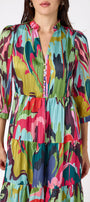 Macrostie Dress in Life of the Party featuring a tiered midi skirt and gold-accented buttons on model – CROSBY by Mollie Burch