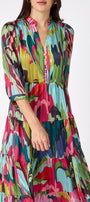 Macrostie Dress in Life of the Party featuring a tiered midi skirt and gold-accented buttons on model – CROSBY by Mollie Burch