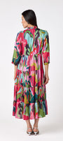Macrostie Dress in Life of the Party featuring a tiered midi skirt and gold-accented buttons on model – CROSBY by Mollie Burch