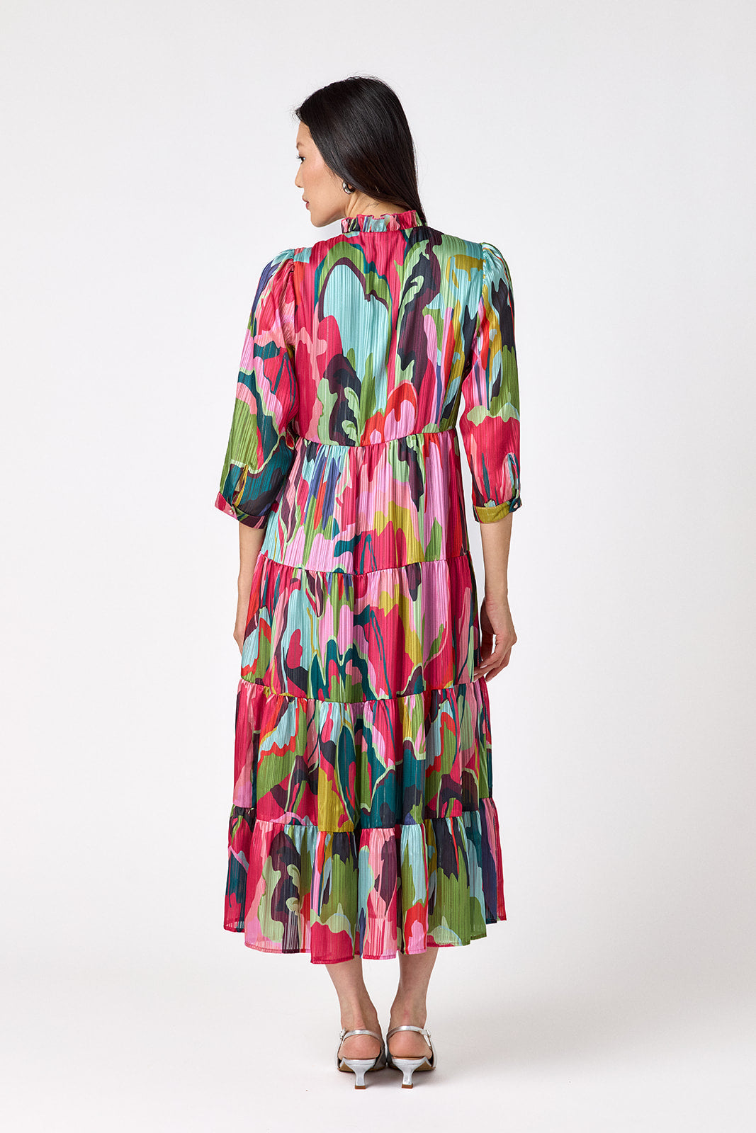 Macrostie Dress in Life of the Party featuring a tiered midi skirt and gold-accented buttons on model – CROSBY by Mollie Burch