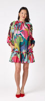 Flynn Dress in Life of the Party featuring puff sleeves and ruffle detailing on model – CROSBY by Mollie Burch