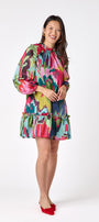 Flynn Dress in Life of the Party featuring puff sleeves and ruffle detailing on model – CROSBY by Mollie Burch