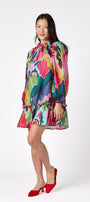 Flynn Dress in Life of the Party featuring puff sleeves and ruffle detailing on model – CROSBY by Mollie Burch