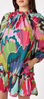 Flynn Dress in Life of the Party featuring puff sleeves and ruffle detailing on model – CROSBY by Mollie Burch
