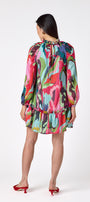 Flynn Dress in Life of the Party featuring puff sleeves and ruffle detailing on model – CROSBY by Mollie Burch