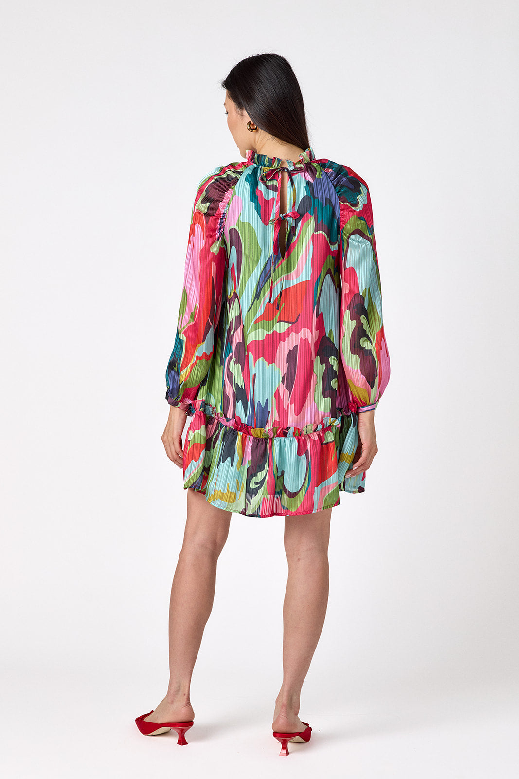 Flynn Dress in Life of the Party featuring puff sleeves and ruffle detailing on model – CROSBY by Mollie Burch