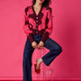 Catwalk Pink v-neck cardigan with scallop detail on model – CROSBY by Mollie Burch