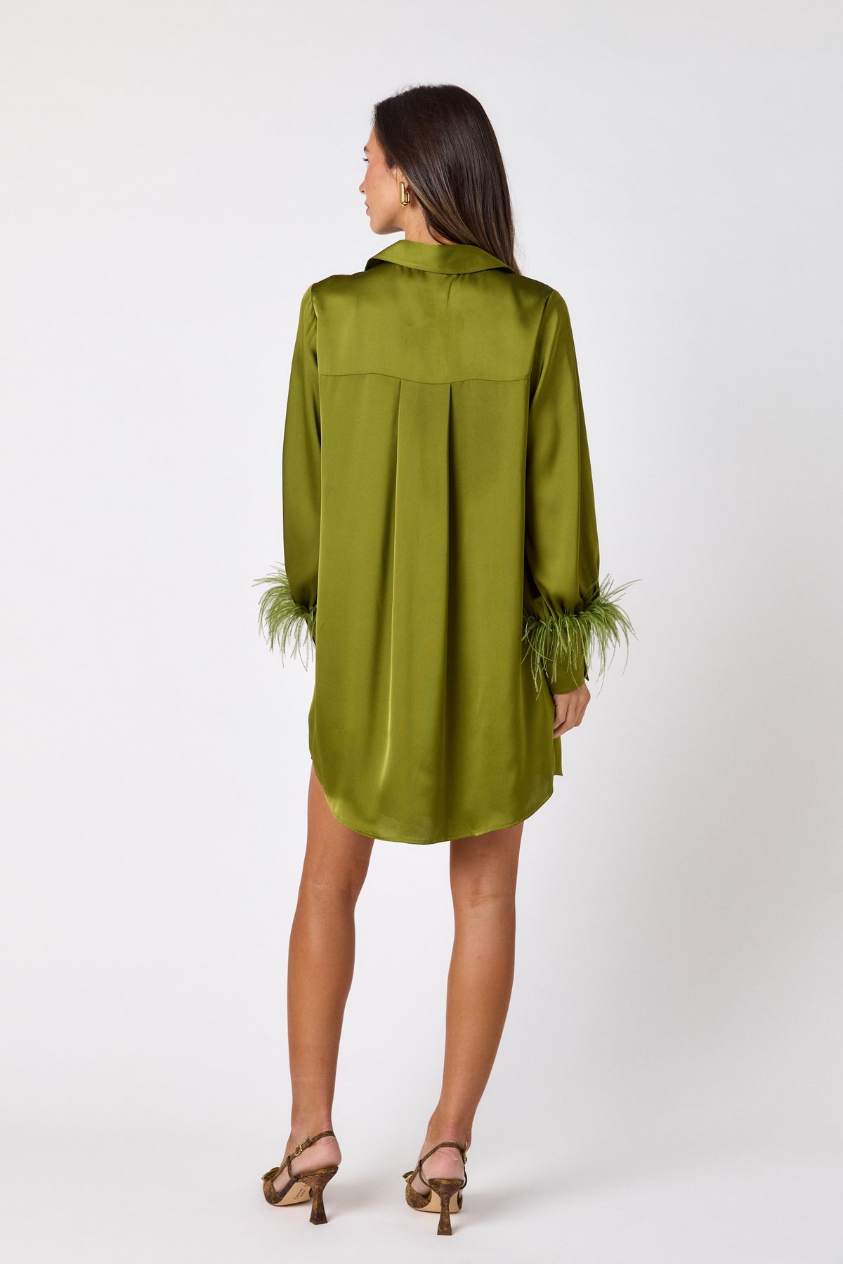 Crawford Dress in Martini featuring ostrich feather cuffs and button-front detailing on model – CROSBY by Mollie Burch