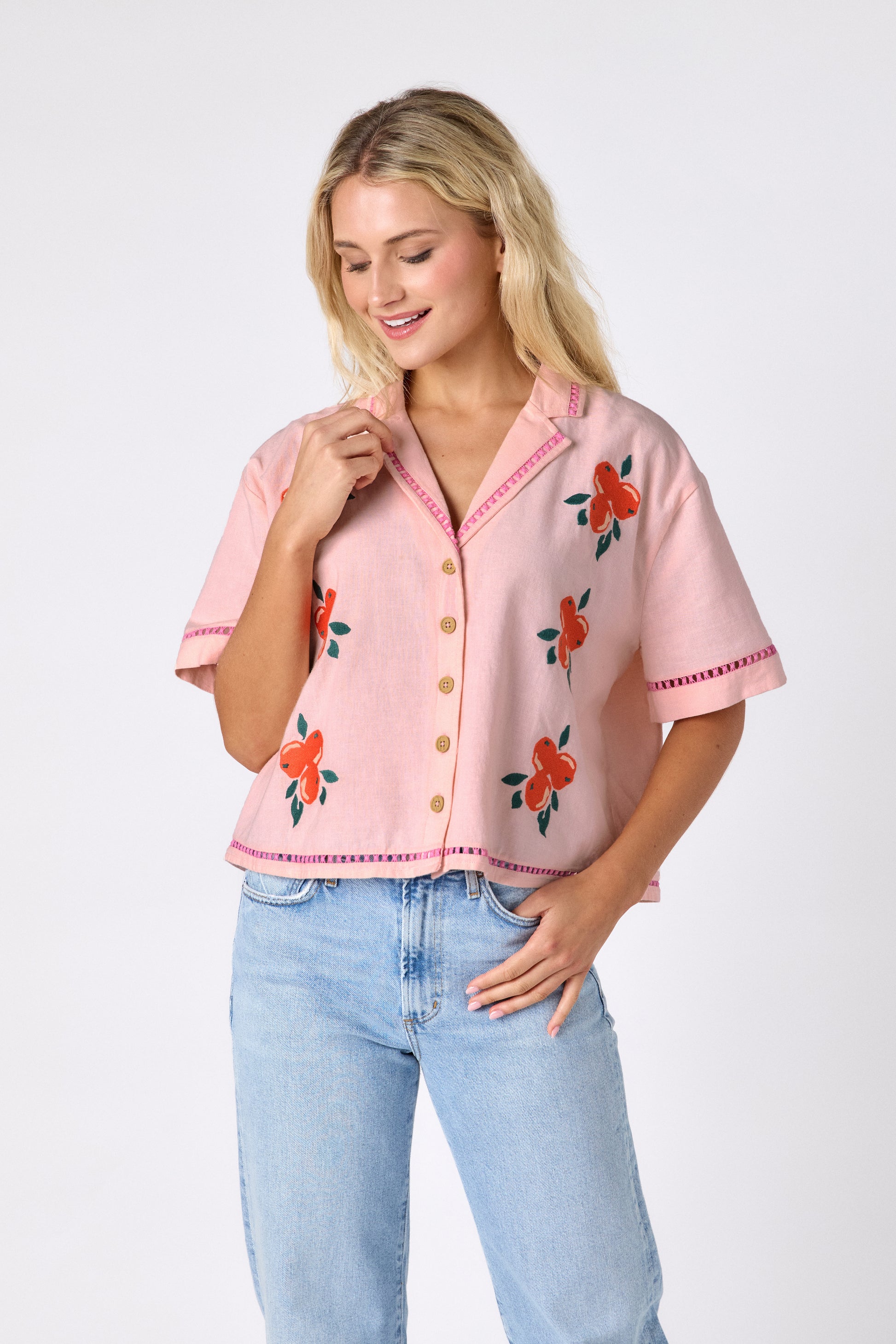 Orange Crush short sleeve collared buttondown with orange embroidery detail on model — CROSBY by Mollie Burch