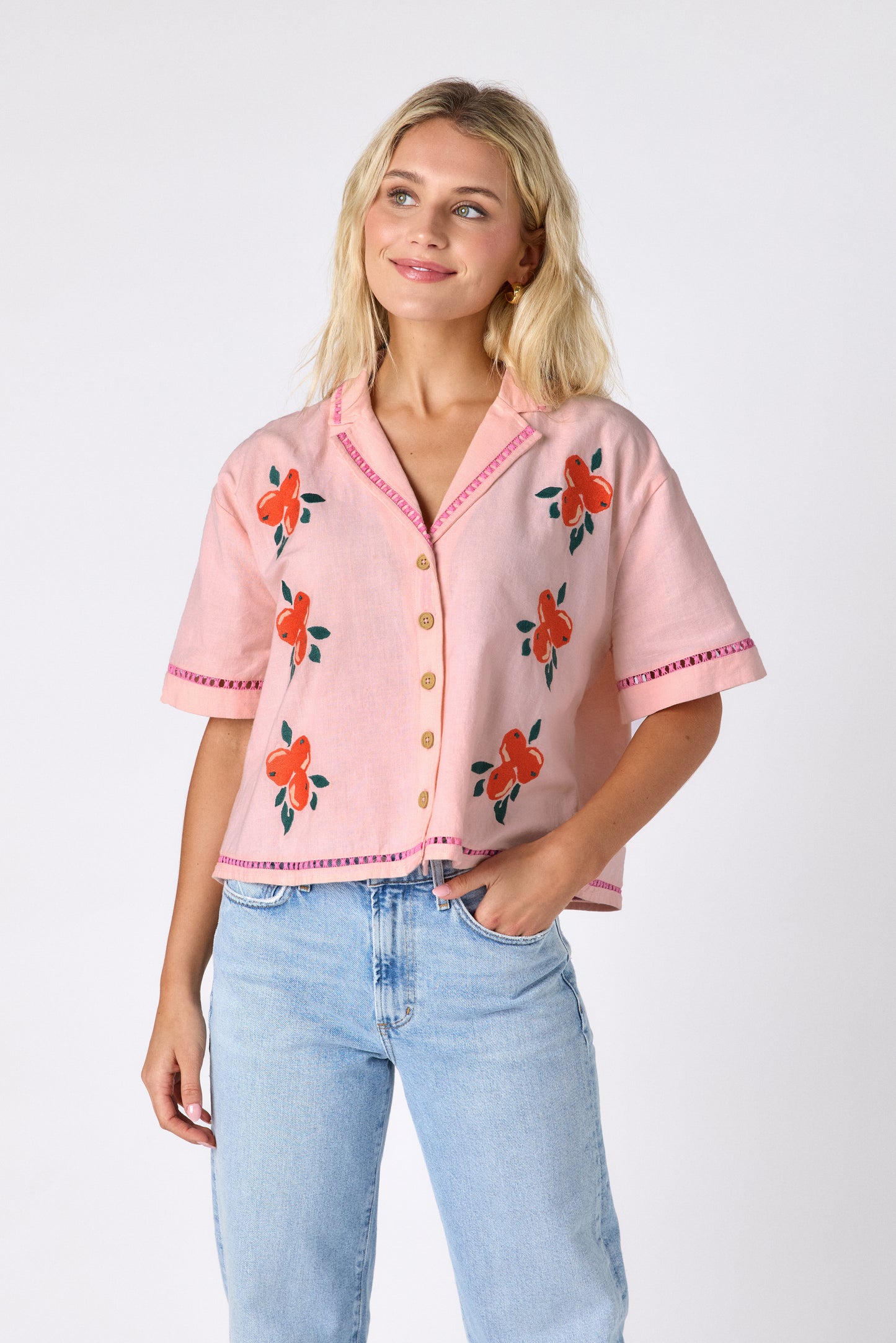Orange Crush short sleeve collared buttondown with orange embroidery detail on model — CROSBY by Mollie Burch