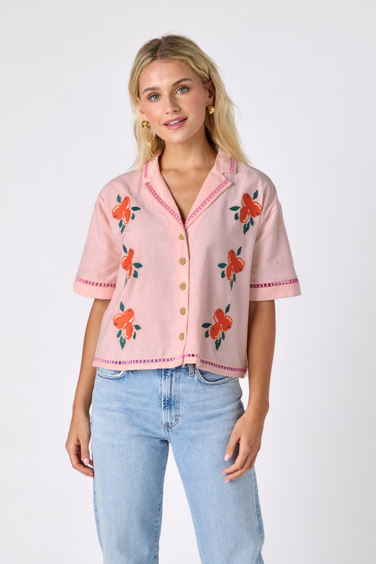Orange Crush short sleeve collared buttondown with orange embroidery detail on model — CROSBY by Mollie Burch