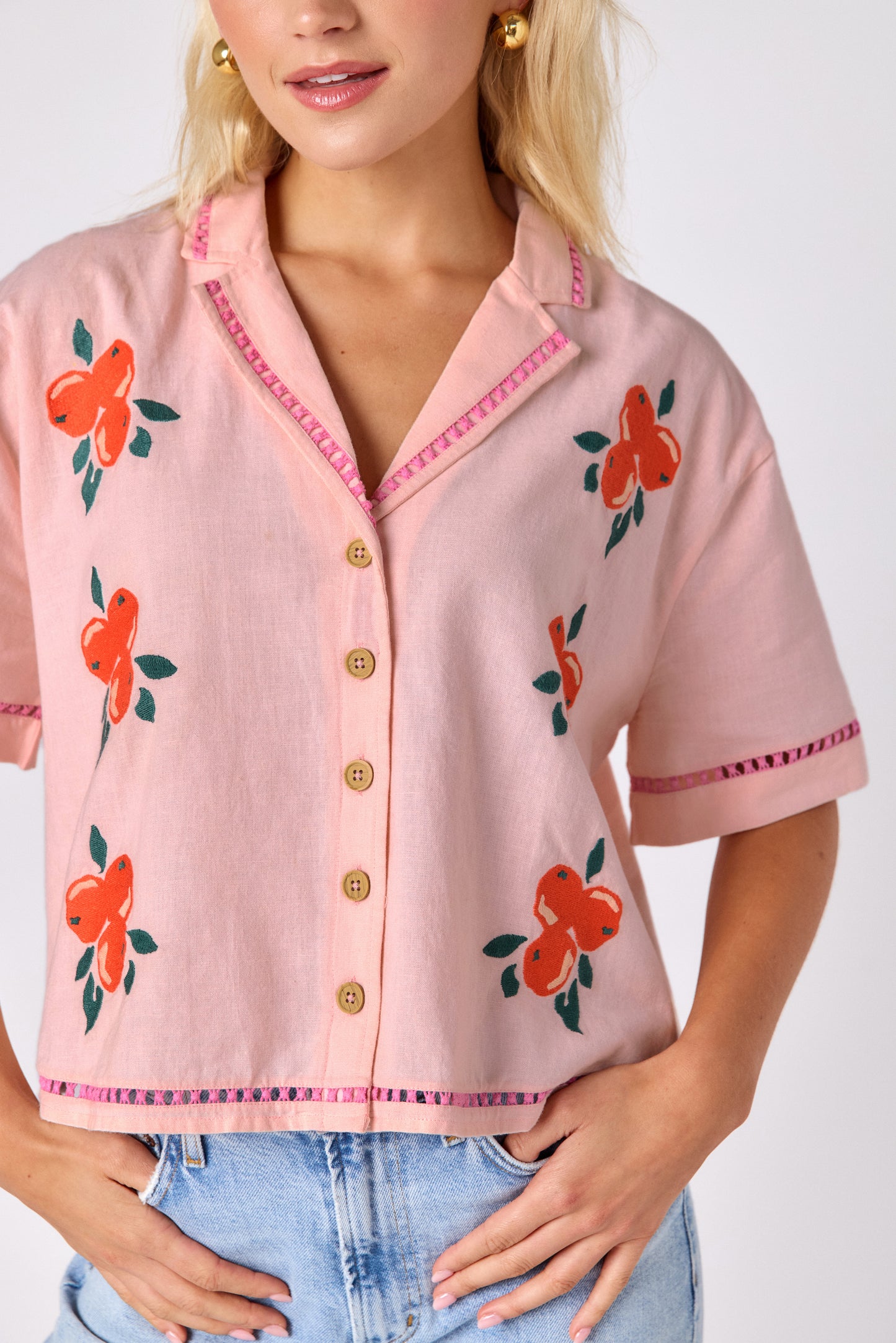 Orange Crush short sleeve collared buttondown with orange embroidery detail on model — CROSBY by Mollie Burch