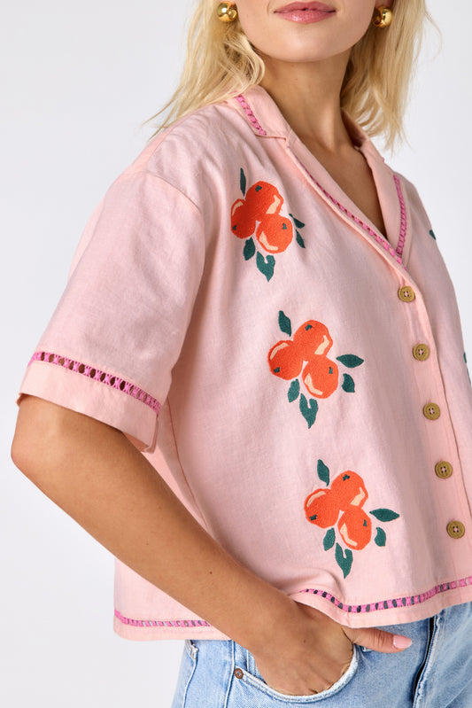 Orange Crush short sleeve collared buttondown with orange embroidery detail on model — CROSBY by Mollie Burch