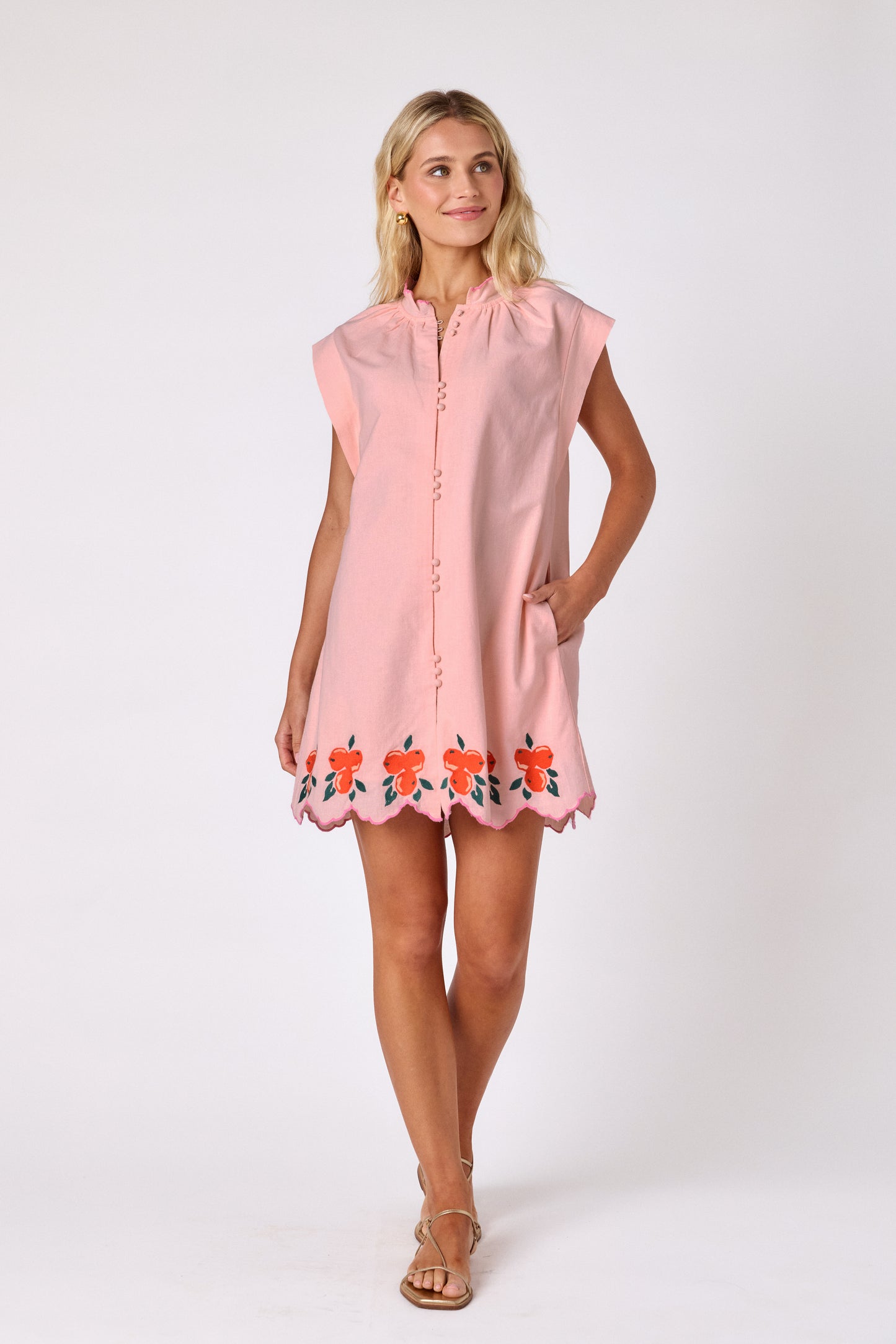 Orange Crush button-front mini dress with orange embroidery detail and scallop hem on model — CROSBY by Mollie Burch