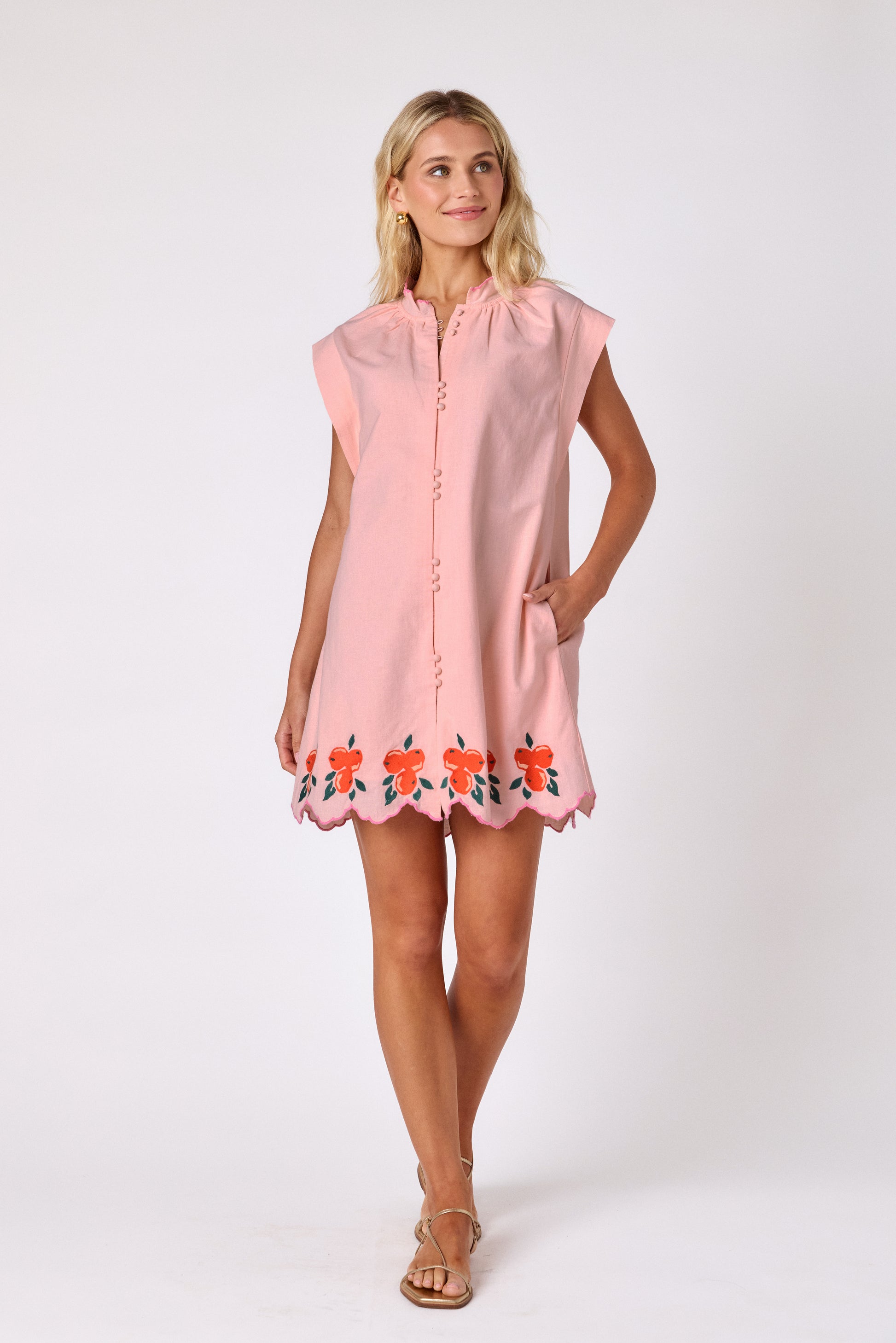 Orange Crush button-front mini dress with orange embroidery detail and scallop hem on model — CROSBY by Mollie Burch
