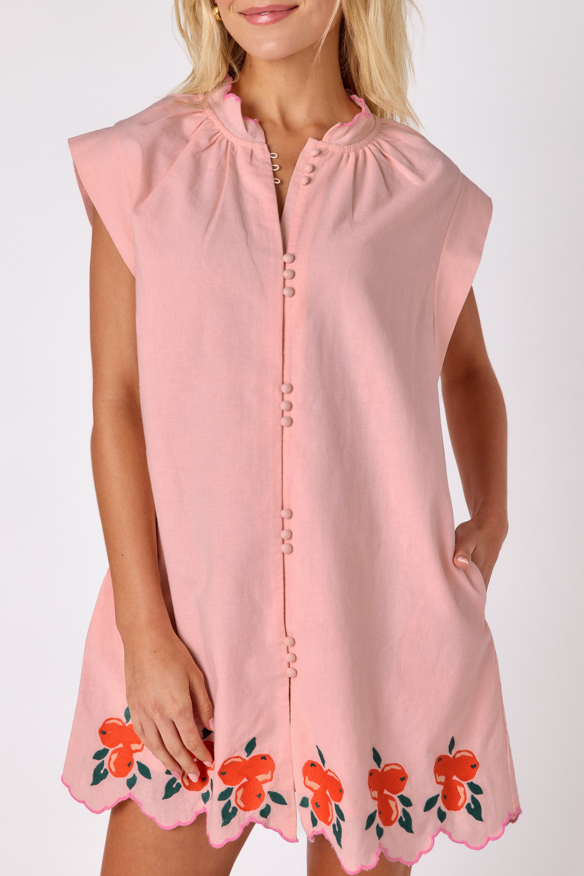 Orange Crush button-front mini dress with orange embroidery detail and scallop hem on model — CROSBY by Mollie Burch