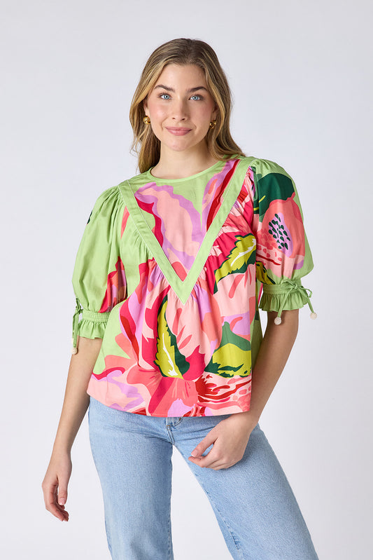 Orchid puff sleeve top with tie detail on model — CROSBY by Mollie Burch