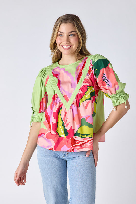 Orchid puff sleeve top with tie detail on model — CROSBY by Mollie Burch