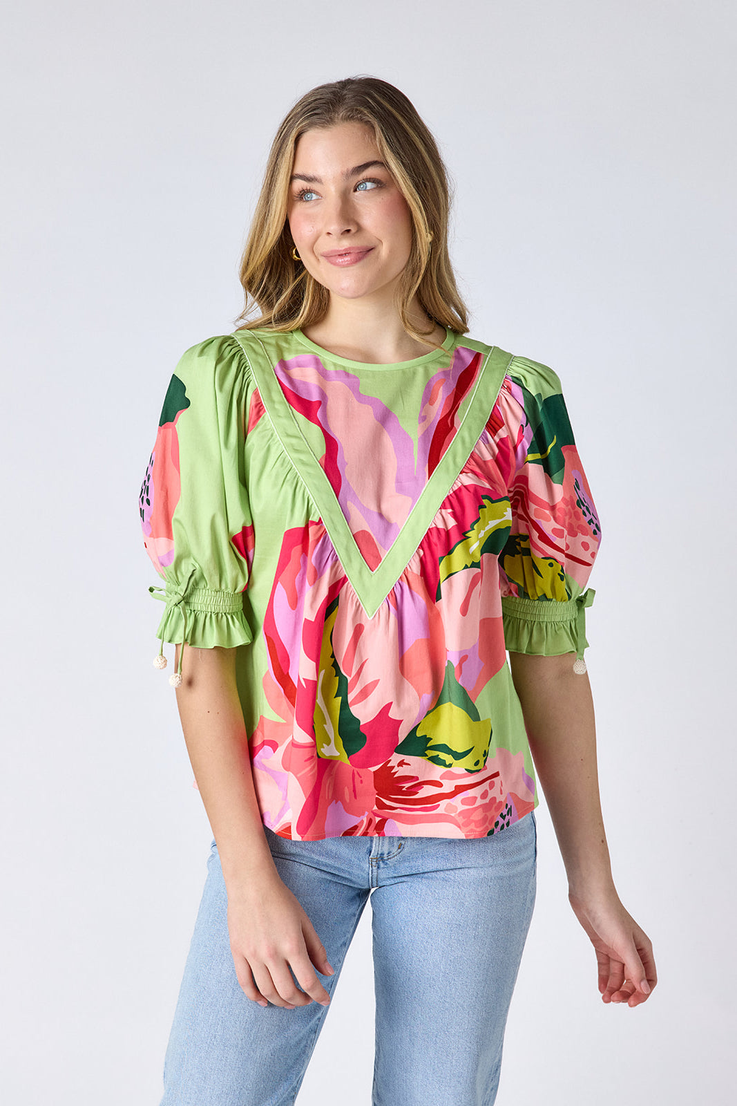 Orchid puff sleeve top with tie detail on model — CROSBY by Mollie Burch
