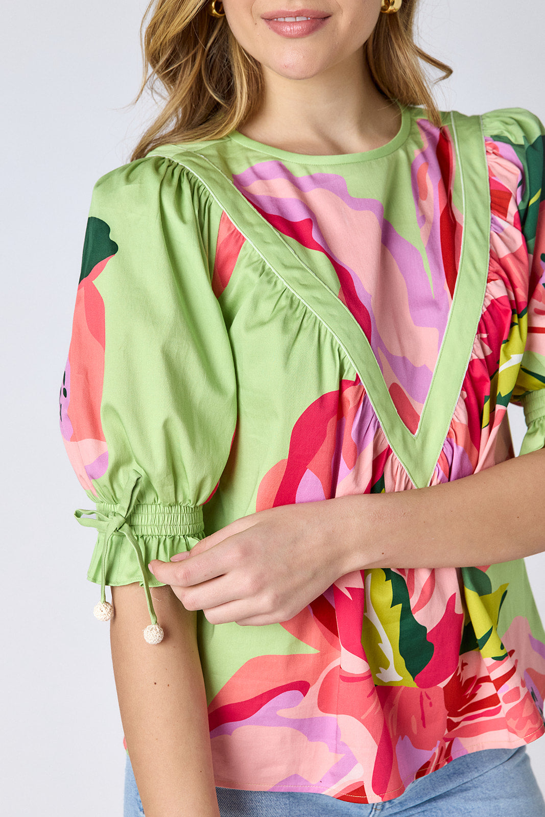 Orchid puff sleeve top with tie detail on model — CROSBY by Mollie Burch