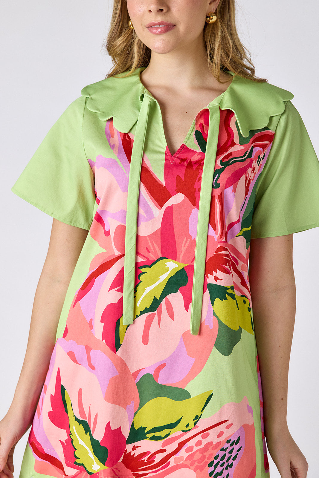 Orchid mini dress with scalloped collar and hem on model — CROSBY by Mollie Burch