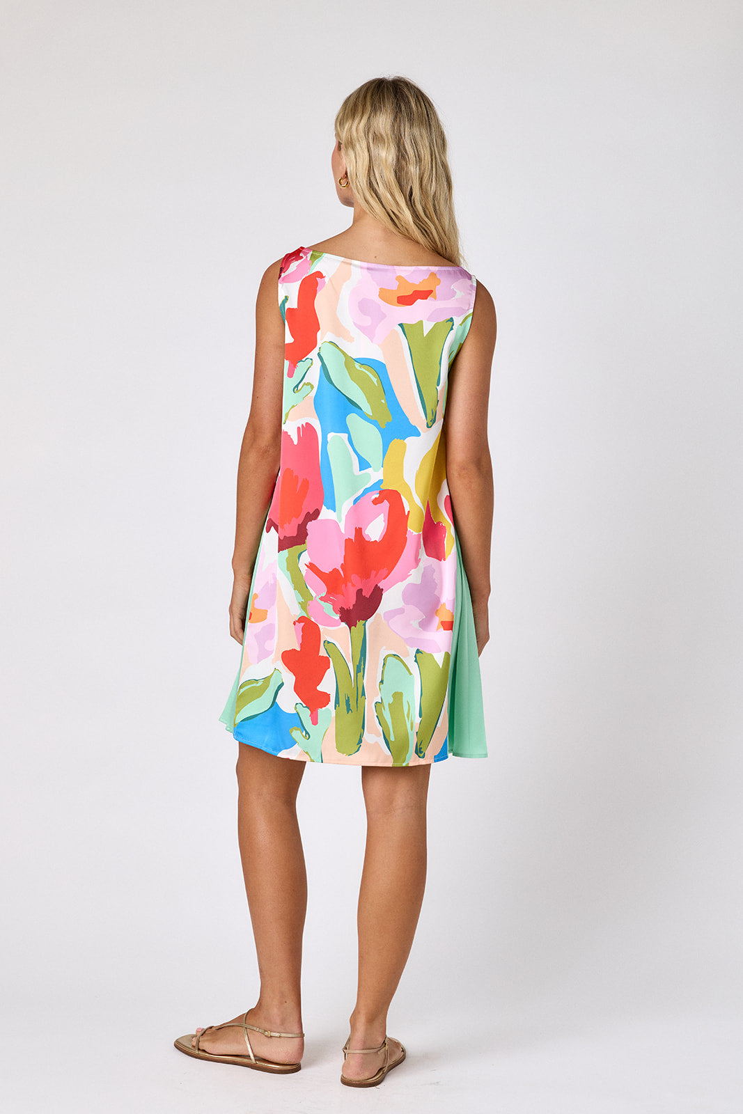 Painted Petals tent style mini dress with side pleat detail on model — CROSBY by Mollie Burch