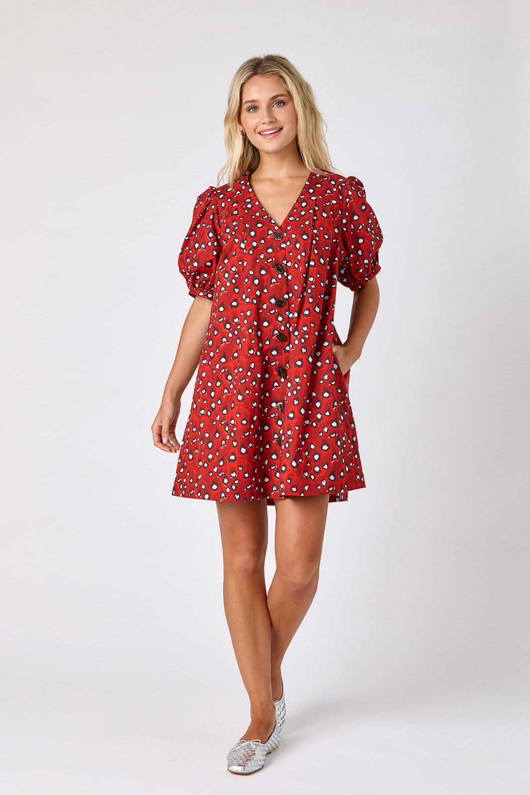 Pheasant v-neck dress with puff sleeves and a swingy silhouette on model — CROSBY by Mollie Burch