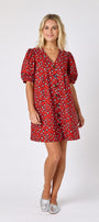 Pheasant v-neck dress with puff sleeves and a swingy silhouette on model — CROSBY by Mollie Burch