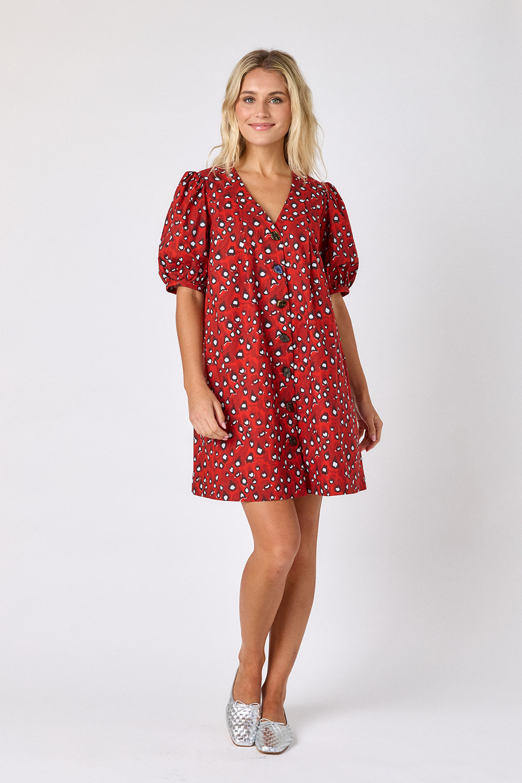 Pheasant v-neck dress with puff sleeves and a swingy silhouette on model — CROSBY by Mollie Burch