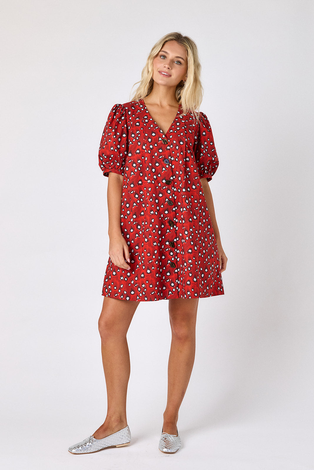 Pheasant v-neck dress with puff sleeves and a swingy silhouette on model — CROSBY by Mollie Burch