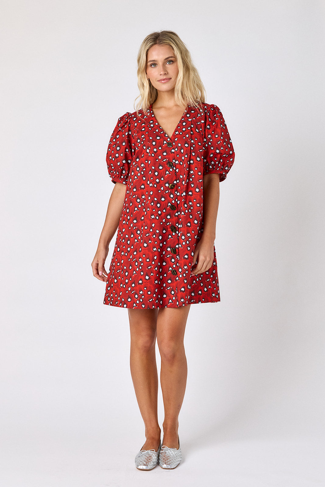 Pheasant v-neck dress with puff sleeves and a swingy silhouette on model — CROSBY by Mollie Burch