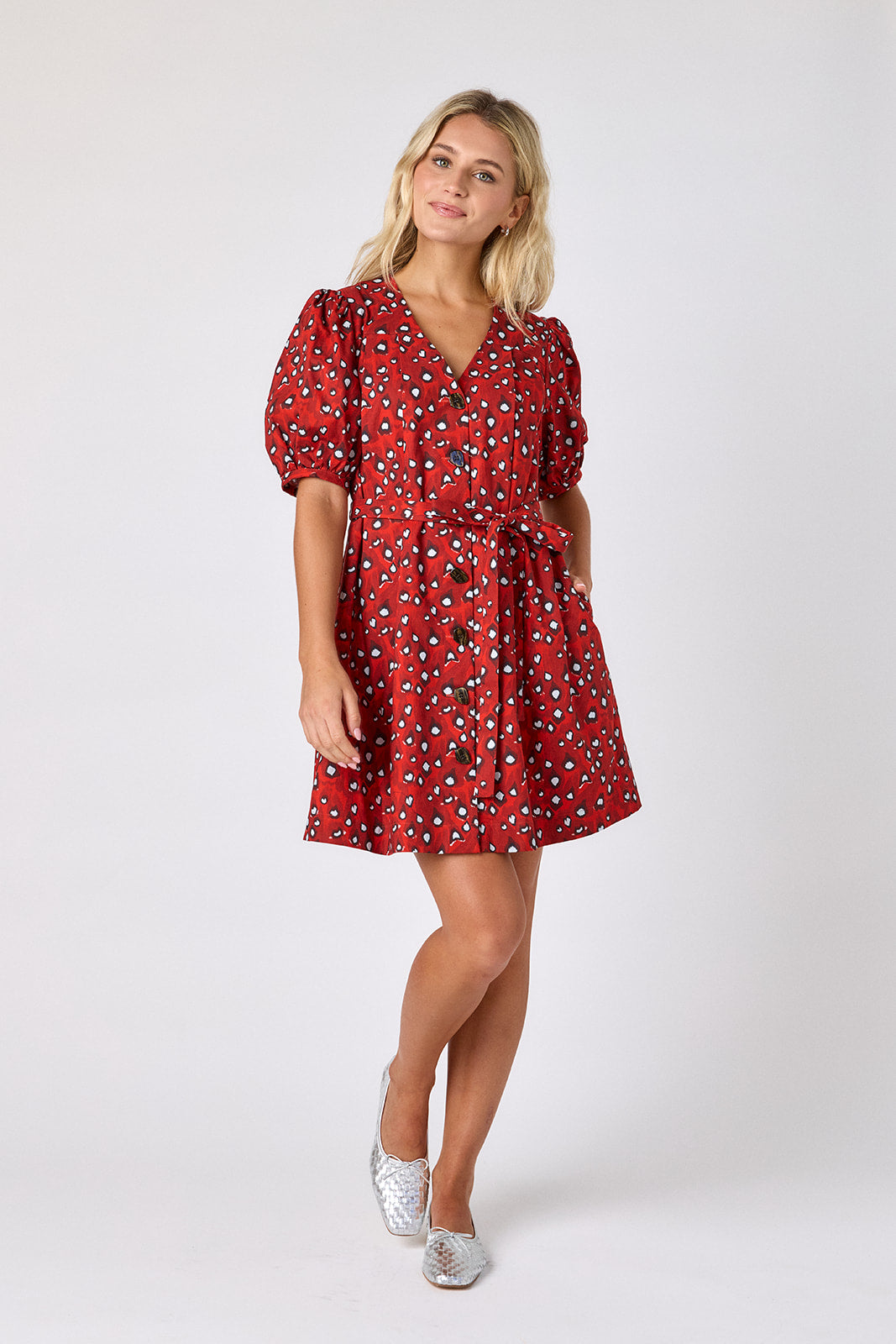 Pheasant v-neck dress with puff sleeves and a swingy silhouette on model — CROSBY by Mollie Burch