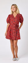 Pheasant v-neck dress with puff sleeves and a swingy silhouette on model — CROSBY by Mollie Burch