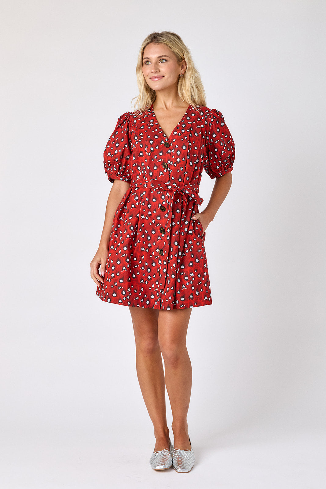 Pheasant v-neck dress with puff sleeves and a swingy silhouette on model — CROSBY by Mollie Burch