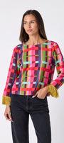 Maya Top in Plaid Parade featuring contrast fringe sleeve cuffs and back neck tie detailing on model – CROSBY by Mollie Burch