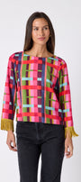 Maya Top in Plaid Parade featuring contrast fringe sleeve cuffs and back neck tie detailing on model – CROSBY by Mollie Burch