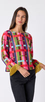 Maya Top in Plaid Parade featuring contrast fringe sleeve cuffs and back neck tie detailing on model – CROSBY by Mollie Burch