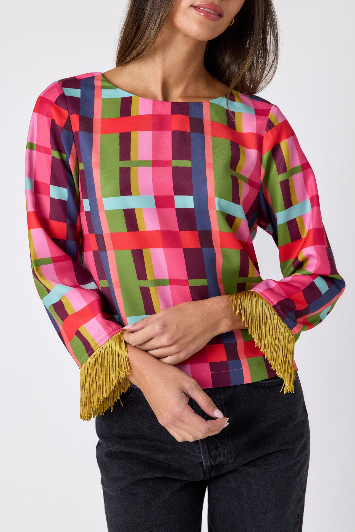 Maya Top in Plaid Parade featuring contrast fringe sleeve cuffs and back neck tie detailing on model – CROSBY by Mollie Burch